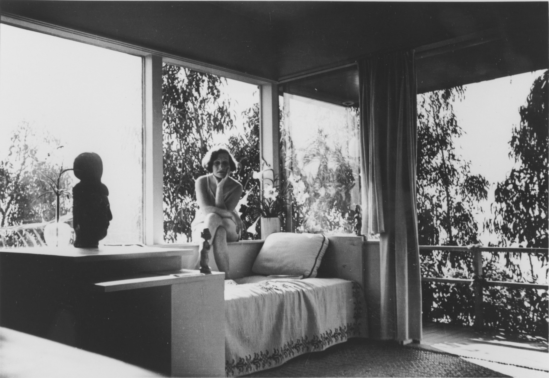 Galka Scheyer in her Hollywood Hills house designed by Richard Neutra. Lette Vaselka, <em>Galka Scheyer in Sunsuit, Seated on Windowsill</em>, ca. 1940-43. Photograph, 3 1/2 x 4 3/4 in. Courtesy of the Blue Four Galka Scheyer Collection Archives, Norton Simon Museum, Pasadena, CA. 