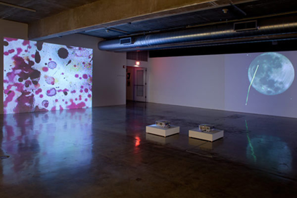 Installation View of "Perspectives 171: Jennifer West," Contemporary Art Museum, Houston, 2010. From left: <em>Lavender Mist Film/Pollock Film 1 (70mm film leader rubbed with Jimson Weed Trumpet flowers, spraypainted, dripped and splattered with nail polish, sprayed with lavender mist air freshener)</em>, 2009. 46 sec. <em>Shred the Gnar Full Moon Film Noir (35mm film print and negative shredded and stomped on by a bunch of Snowboarders and a few Skiers getting ginormous catching air during Aspen Big Air Competition and Fallen Friends Event– marked up with blue course dye - sprayed with Diet Coke, Bud Lite & Whiskey - taken hot tubbing with Epsom salts, rubbed with Arnica, K-Y Jelly, butter and Advil – full moon shot by Peter West)</em> 2010. 5 min, 9 sec. Photo: Rick Gardner.